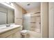 Cozy bathroom featuring a shower-tub combo and a traditional vanity with plenty of lighting at 8335 Fairmount Dr # 9-206, Denver, CO 80247