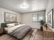 Serene bedroom with a neutral color palette, large window, and modern furnishings for a relaxing retreat at 8335 Fairmount Dr # 9-206, Denver, CO 80247