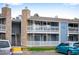 Charming condo building featuring stone accents, private balconies, and well-maintained landscaping at 8335 Fairmount Dr # 9-206, Denver, CO 80247