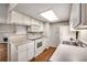 Kitchen featuring white cabinets, ample counter space and essential appliances at 8335 Fairmount Dr # 9-206, Denver, CO 80247