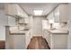 Efficient kitchen with white cabinets, sleek countertops and essential appliances at 8335 Fairmount Dr # 9-206, Denver, CO 80247