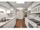 Well-lit kitchen with white appliances and cabinets, offering ample storage and counter space at 8335 Fairmount Dr # 9-206, Denver, CO 80247