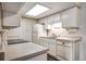Efficient kitchen with white cabinetry, modern appliances, and ample countertop space for easy meal preparation at 8335 Fairmount Dr # 9-206, Denver, CO 80247
