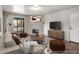 Bright living room featuring a fireplace, balcony access, modern furniture, and wood flooring at 8335 Fairmount Dr # 9-206, Denver, CO 80247