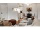 Open-concept living and dining area with modern furnishings, wood floors, and a view into the kitchen at 8335 Fairmount Dr # 9-206, Denver, CO 80247