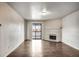 Spacious, empty living area with a fireplace and balcony access, ready for personalization at 8335 Fairmount Dr # 9-206, Denver, CO 80247