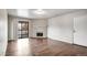 Bright living room featuring a fireplace, hardwood floors, and access to a balcony at 8335 Fairmount Dr # 9-206, Denver, CO 80247