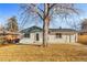 Charming backyard of a home featuring a spacious yard and mature tree at 127 Emerald St, Broomfield, CO 80020