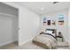 Bright bedroom featuring minimalist decor, wood nightstands, and artwork on the wall at 127 Emerald St, Broomfield, CO 80020