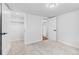 Bright bedroom featuring neutral carpet, white walls and trim, and access to closet and bathroom at 127 Emerald St, Broomfield, CO 80020