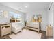 Bright Bedroom with crib, rocking chair, light wood furniture, and natural light at 127 Emerald St, Broomfield, CO 80020