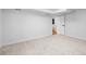 Spacious bedroom leading to bathroom, carpeted and painted white at 127 Emerald St, Broomfield, CO 80020