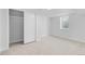 Cozy bedroom featuring an open closet and light carpet with a single window at 127 Emerald St, Broomfield, CO 80020