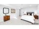 Bright bedroom featuring modern decor, wood nightstands, stylish lamps, and a neutral color palette at 127 Emerald St, Broomfield, CO 80020