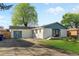 Charming single-story home featuring a white brick exterior, a well-manicured lawn, and lovely curb appeal at 127 Emerald St, Broomfield, CO 80020