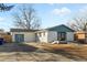 Charming home featuring a blue garage, well-manicured lawn and updated exterior at 127 Emerald St, Broomfield, CO 80020