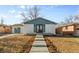 Charming home featuring a well-manicured lawn, landscaped bushes and concrete walkway at 127 Emerald St, Broomfield, CO 80020