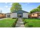 Charming home featuring a well-manicured lawn, landscaped bushes and concrete walkway at 127 Emerald St, Broomfield, CO 80020