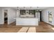 Modern kitchen features a spacious center island, designer lighting, and stainless steel appliances at 127 Emerald St, Broomfield, CO 80020