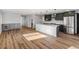 Open-concept kitchen boasts a large island, stainless steel appliances, and custom cabinetry at 127 Emerald St, Broomfield, CO 80020