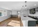 Bright, open-concept kitchen with stainless steel appliances and modern fixtures at 127 Emerald St, Broomfield, CO 80020