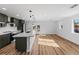 Spacious kitchen with a large island, pendant lighting, stainless steel appliances, and dark green cabinetry at 127 Emerald St, Broomfield, CO 80020