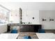 Modern kitchen space with pendant lighting, bar seating, and sleek black appliances at 1313 N Williams St # 1003, Denver, CO 80218