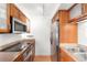 Efficient kitchen with stainless steel appliances, wood cabinets and countertops at 1313 N Williams St # 1003, Denver, CO 80218