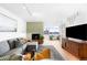 Living room with a comfortable sectional, fireplace, natural light and an entertainment center at 1313 N Williams St # 1003, Denver, CO 80218