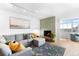 Bright living room features a charming fireplace, comfortable gray sectional and stylish decor at 1313 N Williams St # 1003, Denver, CO 80218