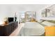 Bright main bedroom features neutral tones, light hardwood floors, and a closet with mirrored sliding doors at 1313 N Williams St # 1003, Denver, CO 80218