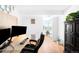 This bright office features a modern desk, dual monitors, and lovely neighborhood views at 1313 N Williams St # 1003, Denver, CO 80218