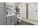 Modern bathroom features a glass enclosed shower with white subway tile and sleek grey vanity with stainless hardware at 2560 Champa St, Denver, CO 80205