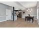 Dining area featuring an elegant chandelier and seamlessly flowing into the modern kitchen at 2560 Champa St, Denver, CO 80205