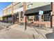 Brick exterior showcases windows, outdoor seating, and a convenient bike rack for a vibrant urban lifestyle at 2560 Champa St, Denver, CO 80205