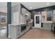 Modern kitchen featuring stainless steel appliances, light grey cabinets, and dark blue accent wall at 2560 Champa St, Denver, CO 80205
