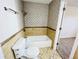 Bathroom with tiled walls, tiled floors, and bath tub with shower head at 4623 S Lowell Blvd, Denver, CO 80236