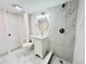 Updated bathroom featuring marble tiled shower and white vanity with gold mirror at 4623 S Lowell Blvd, Denver, CO 80236