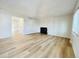 Spacious living room with wood-look flooring and fireplace at 4623 S Lowell Blvd, Denver, CO 80236
