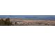 Expansive aerial view of property with rolling hills and mountain backdrop on a clear day at 6275 Ponderosa Way, Parker, CO 80134