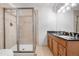 Tiled bathroom showcasing a glass shower and double vanity with granite countertops at 6275 Ponderosa Way, Parker, CO 80134