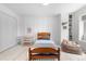 Cozy bedroom featuring a hardwood bedframe, wooden shelving unit, and a comfortable beanbag chair at 6275 Ponderosa Way, Parker, CO 80134
