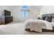 Bright, spacious bedroom with neutral tones, soft carpet, a large window and contemporary furnishings at 6275 Ponderosa Way, Parker, CO 80134