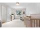 Bright bedroom features a crib, changing table, natural light and wood-paneled walls at 6275 Ponderosa Way, Parker, CO 80134