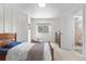 Bedroom with natural light, hardwood bedframe and access to a bathroom with a shower-bath combination at 6275 Ponderosa Way, Parker, CO 80134