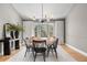 An airy dining room with hardwood floors and large windows at 6275 Ponderosa Way, Parker, CO 80134
