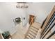 Bright entryway with hardwood floors leading to stairs and an open view of the living room provides a warm welcome at 6275 Ponderosa Way, Parker, CO 80134