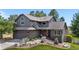 Beautiful two-story home with gray siding, brick accents, mature landscaping, and a well-maintained front yard at 6275 Ponderosa Way, Parker, CO 80134