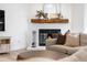 Charming fireplace with mantel, decor, and a comfortable sofa in the living room for cozy evenings at 6275 Ponderosa Way, Parker, CO 80134