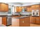 Bright kitchen with a stainless steel dishwasher and oven at 6275 Ponderosa Way, Parker, CO 80134